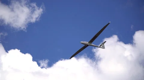 A glider soars under cumulus clouds Stock Footage 63349652