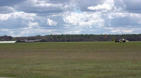 A glider is towed into the air by a powered tug aircraft Stock Footage 63361992