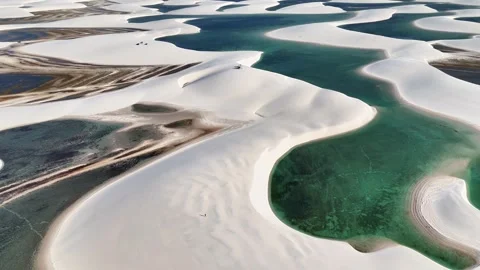 Gliding Along Emerald Lagoon Edges Across White Dunes in Lençóis Maranhenses Video stock 342446141