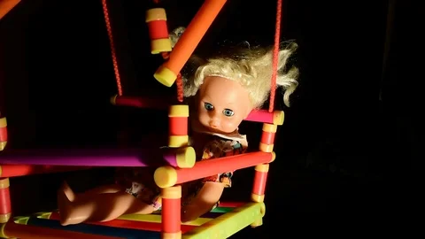 Gliding beam of light illuminates the doll Stock Footage 120246755