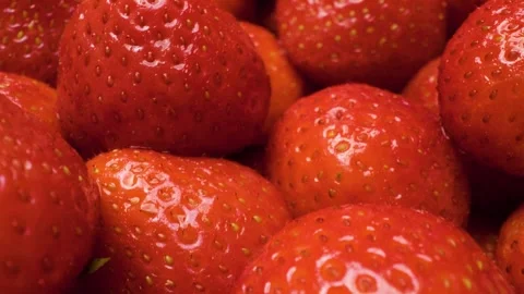 Gliding camera captures an extreme close-up of vibrant strawberries. Stock Footage 313802603