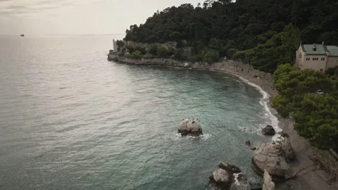 Gliding drone aerial forward over rocky Trieste bay beach 4K Stock-Footage 331048861