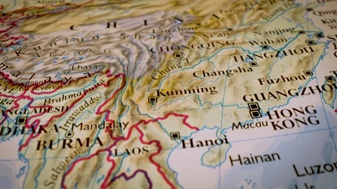 Gliding macro view over physical atlas map from Cambodia to China Stock Footage 340917243
