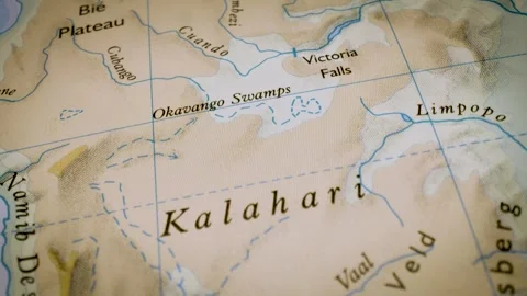Gliding macro view over physical atlas map leading to the Kalahari Desert Stock Footage 341752163