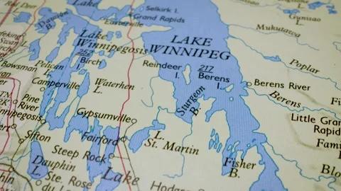 Gliding macro view over physical atlas map showing Lake Winnipeg in Canada Stock Footage 341752281