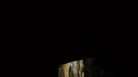 Gliding out of a cave through a melted glacier canyon with golden sunlight. Stock Footage 98686730