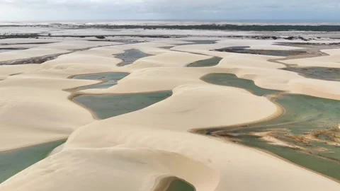 Gliding Over Curving Lagoons and Pale Dunes in Lençóis Maranhenses Video stock 342441917