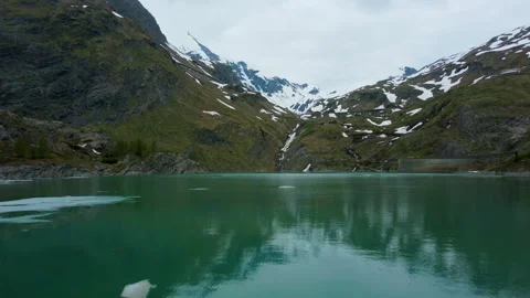 Gliding over the Emerald Green Lake | Austrian Glacier Aerial Drone Footage Stock Footage 243173810