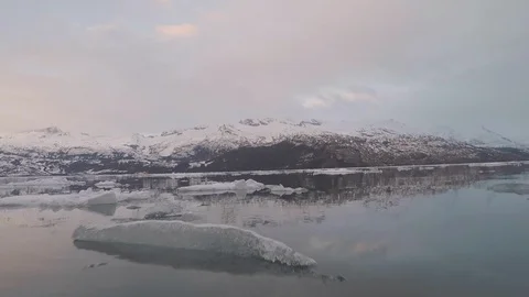 Gliding over icy ocean reflection of fjord  in slow motion Stock Footage 104189319