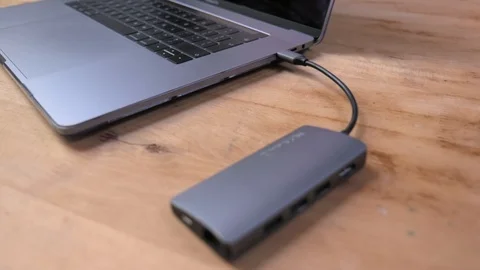 Gliding over a laptop with usb-c hub on wooden desk Stock Footage 120914536