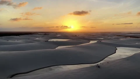 Gliding Over Reflective Sand Channels at Sunset in Lençóis Maranhenses Video stock 342443750
