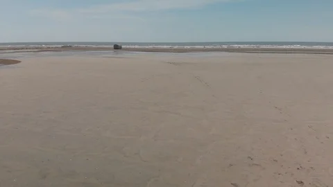 GLIDING OVER SANDY BEACH, CLOSER TO WATER Stock Footage 93552508