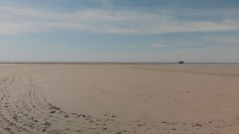 GLIDING OVER SANDY BEACH, FAR FROM WATER Stock Footage 93552511