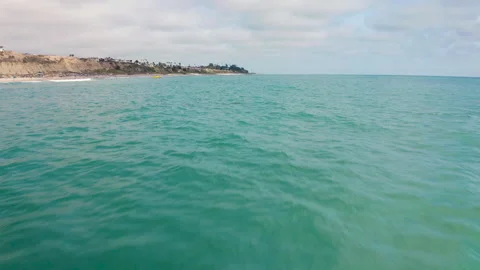 Gliding Super Low Over the Ocean in Orange County Stock Footage