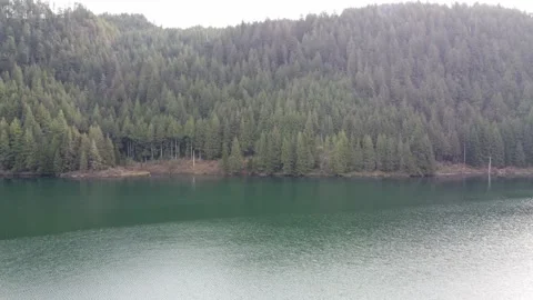 Gliding through a paradise: aerial views of calm lake and forest beneath clouds Vídeos de archivo 296496210