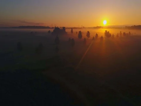 Gliding toward the sunrise over foggy dreamlike landscape Stock Footage