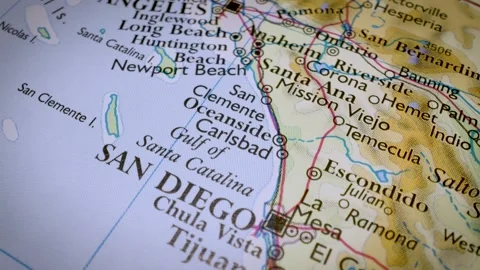 Gliding view over atlas map tracking the route from Los Angeles to San Diego Stock Footage 341750579