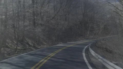 Gliding up a windy mountain road in winter Stock Footage 242347283