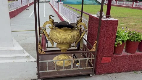 Glimmer of Devotion: Ash in a Gold-Toned Ritual Container Stock Footage 317071563