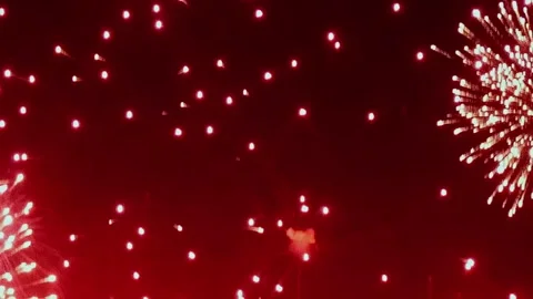 Glimmering explosions light up Fourth of July night sky Stock Footage 313781928