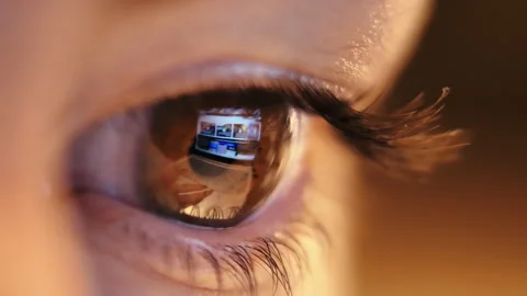 Glimpse of Focus: Close-up of Woman's Eye, Engaged in Laptop Work during Evening Stock Footage 247448677