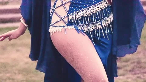 A glimpse of the hips and legs of a beautiful Latina woman dancing belly dance Stock Footage 335552787