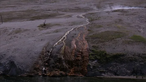 Glimpse at Steaming Water Falling Over Volcanic Rock at Yellowstone Stock Footage 86756361