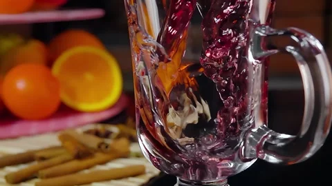 Glintwein is poured into a cup on a background of fruit Stock Footage 292093943