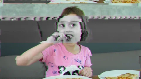 Glitch noise effect. Distortion video. A child, a little girl eating a pancak Stock Footage 122572979