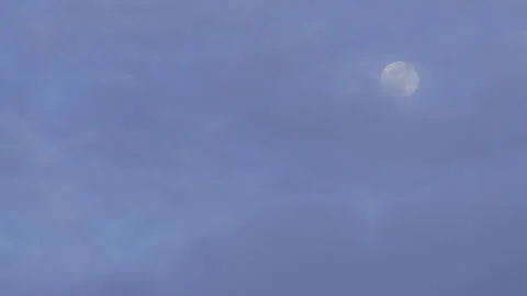 Glitchy look full moon behind clouds on blue sky Stock Footage 170595178