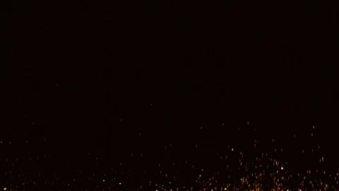 Glitter exploding golden sparkles isolated on black background.Gold glitter dust Stock Footage 99756052