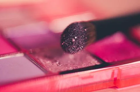 Glitter eye shadows with brush closeup. Make up product. Selective focus. Stock Photos