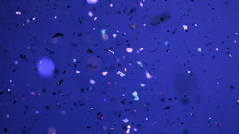 Glitter Falling Against a Blue Backdrop Stock Footage 270403440
