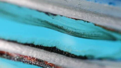 Glitter fluid drip paint spill cyan blue red ink Video stock 283426888