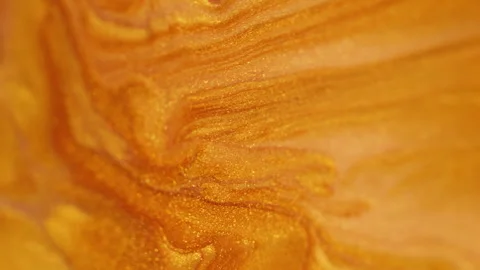 Glitter fluid flow acrylic paint spill golden wave Video stock 281702549