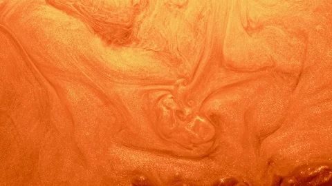 Glitter fluid motion shimmering orange paint whirl Stock Footage 123585524