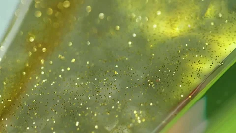 Glitter gel flow sparkling fluid golden green wave Stock Footage 261435011