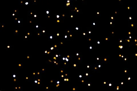 Glitter lights on black background Stock Photos