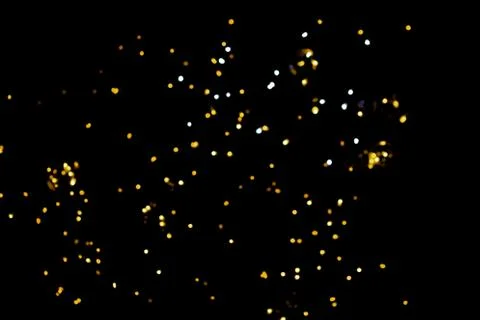 Glitter lights on black background Stock Photos