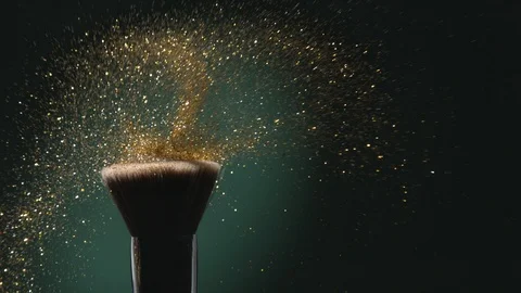 Glitter on a Make-up Brush Flying Away with Woman Finger Flicking Video stock 122118492