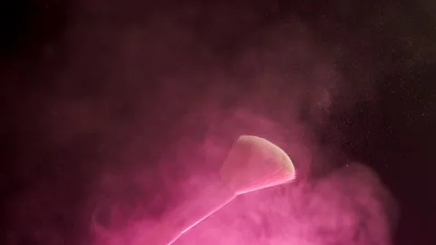 Glitter on a Make-up Brush Flying Away with Brush Flicking Shot in Slow Motion Video stock 194395958