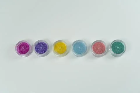 Glitter for manicures and creative projects, displayed on a white background. Stock Photos