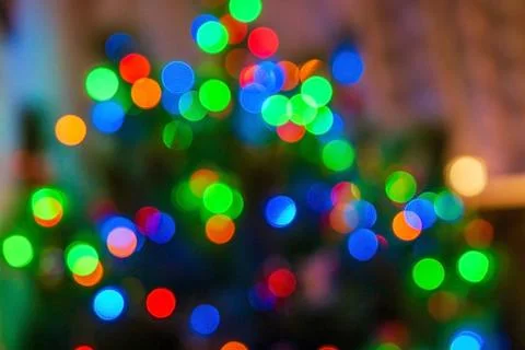 Glitter multicolored light spots on navy brown backdrop defocused Stock Photos