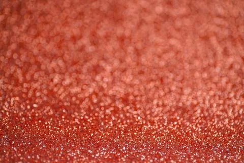 Glitter red background. Texture foil and confetti bokeh, light of red dust Stock Photos