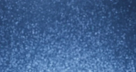 Glittering abstract blue bokeh background. Smoothly increase and decrease the Stock Footage 156707912