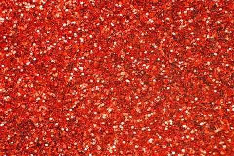 Glittering background of red sequins closeup. Sparkle festive texture Stock Photos