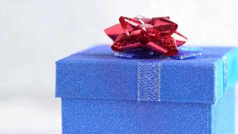 Glittering blue gift box with a red bow rotates. Gift concept or birthday p.. Stock Footage 254326185