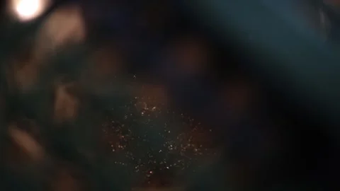 Glittering gold particles illuminated in a dark tunnel, creating a mysterious an Video stock 294786727