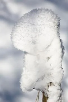 Glittering ice structures on a pile of snow on a pole after a freezing night  Stock Photos