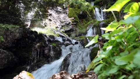 Glittering mountain stream waterfall on a sunny day Stock Footage 70573867